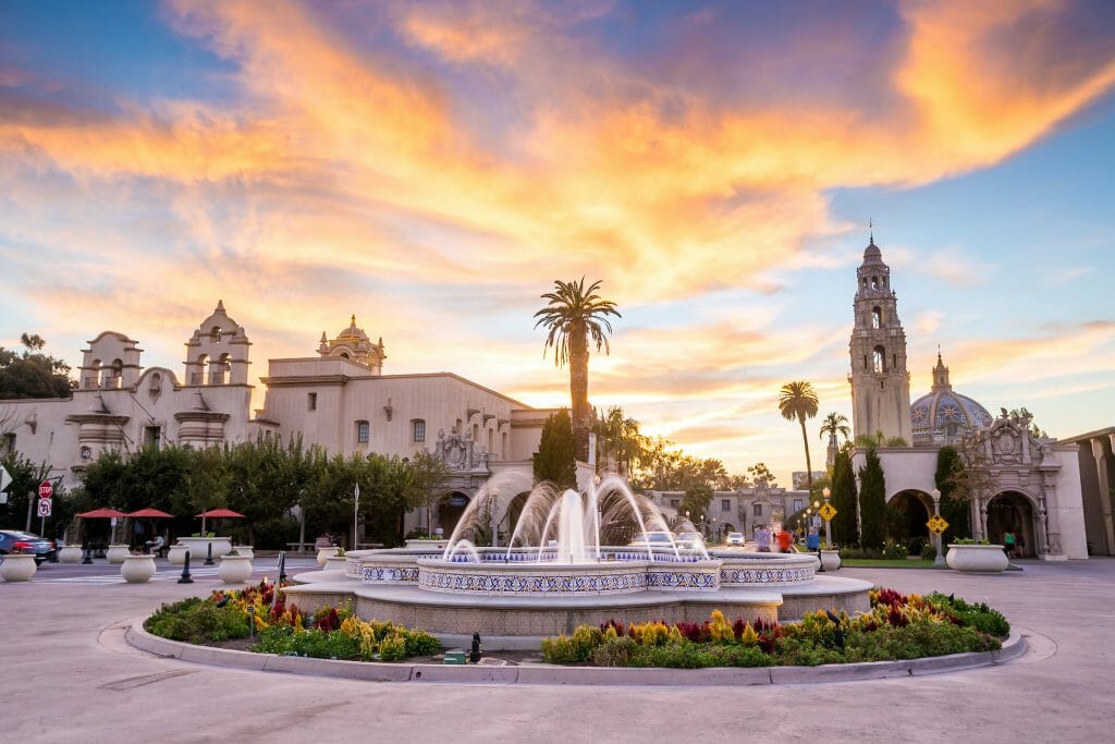 As the sun begins to set, the Balboa Park fountain continues to spits water out beautifully with the surrounding buildings peacefully quiet