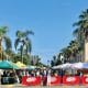 San Diego Farmers Market in Little Italy - Vendor stalls on closed off street under palm trees