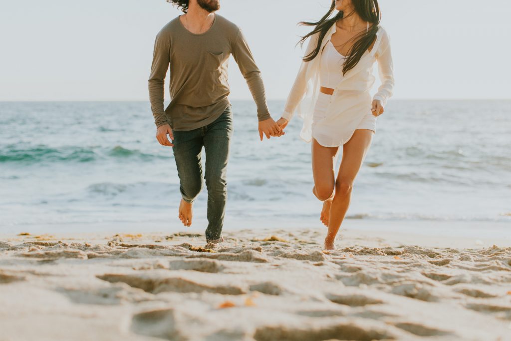 Couple running at the beach - Romantic Staycation in San Diego