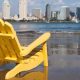 San Diego Staycation - Yellow beach chair on the beach in Coronado with the San Diego Skyline in the background