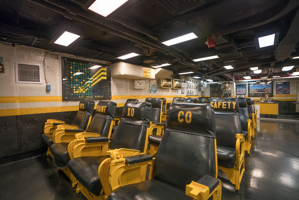 Yellow and black seats in the pilot ready room in the San Diego USS Midway Museum