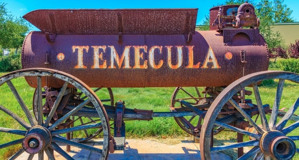 Historic, rusty railway cart with Temecula etched into the side