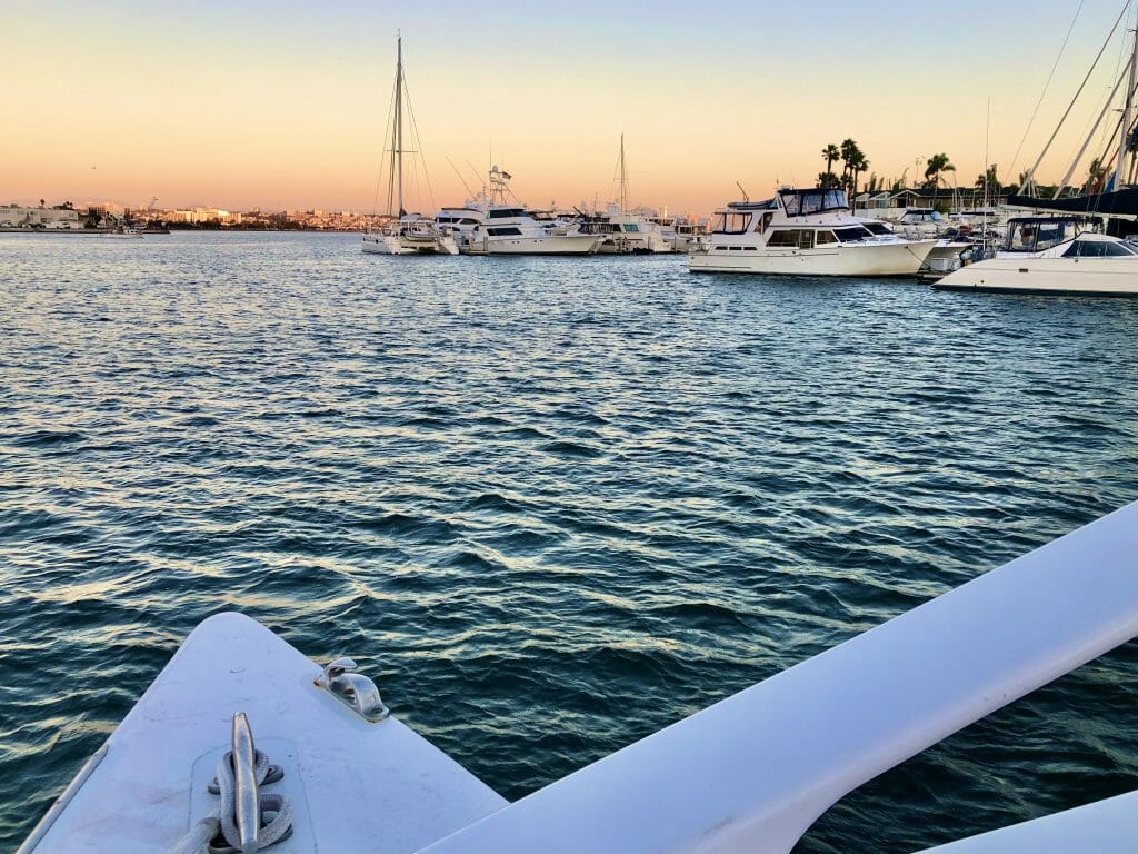 View of the San Diego Marina during sunset with front of the Catamaran in the foreground