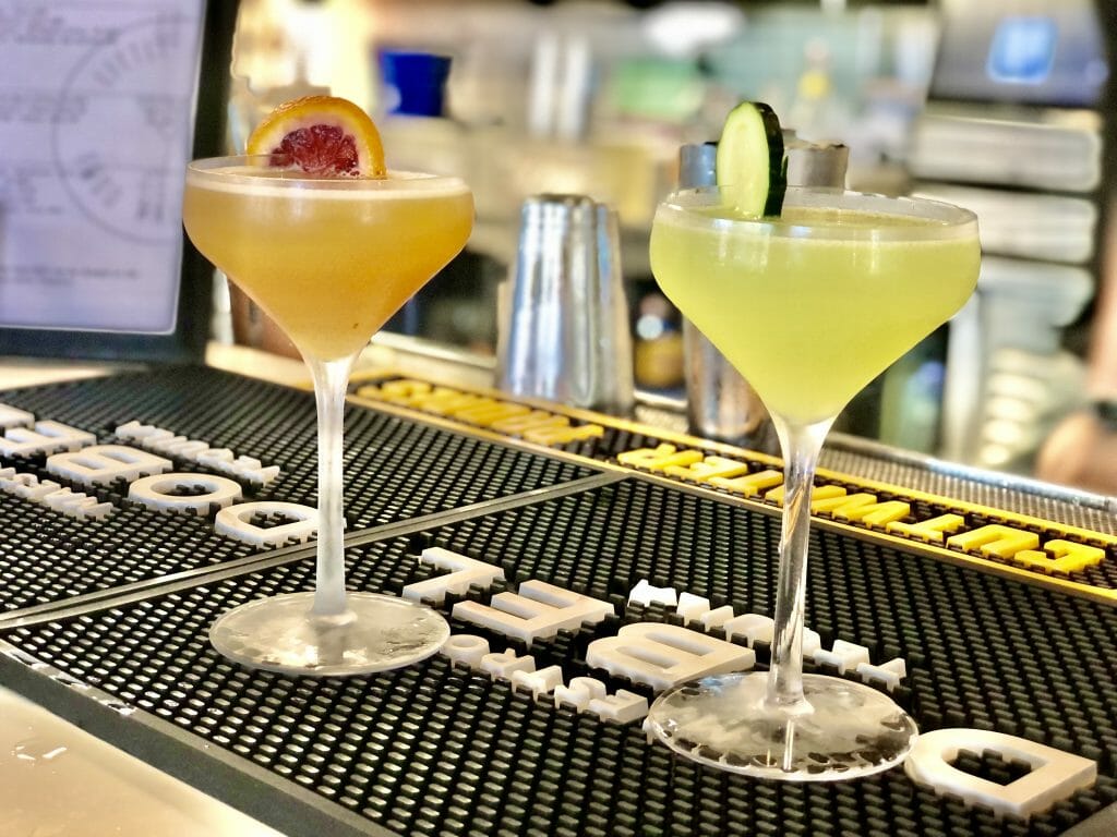 2 Craft Cocktails on the counter at Little Italy Food Hall Bar