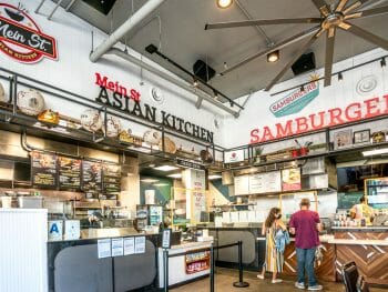 Inside of Little Italy Food Hall - order counters of MeinSt Asian Kitchen & Samburgers food station