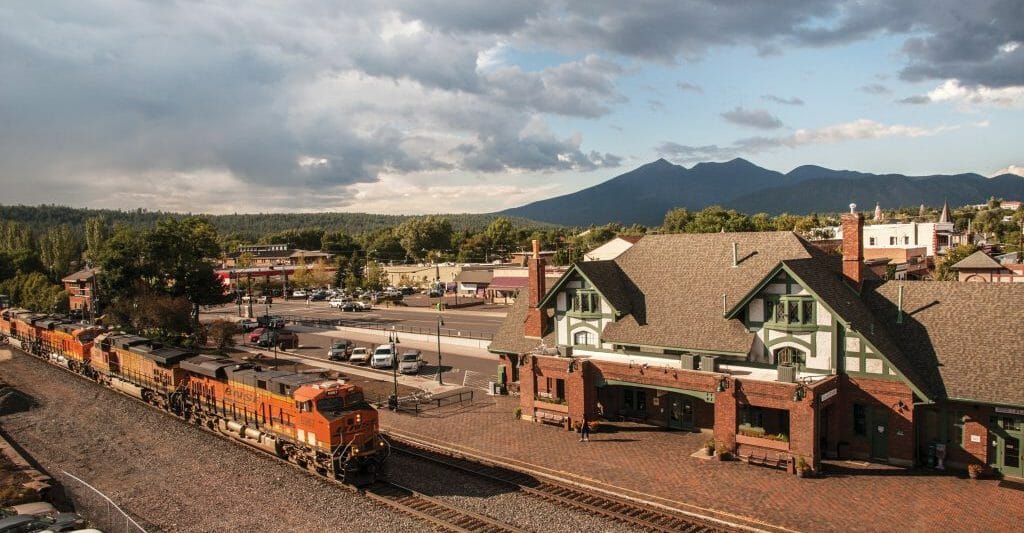 Aerial View of Flagstaff Train station / Flagstaff visitor center and a fright train passing by in front of it.