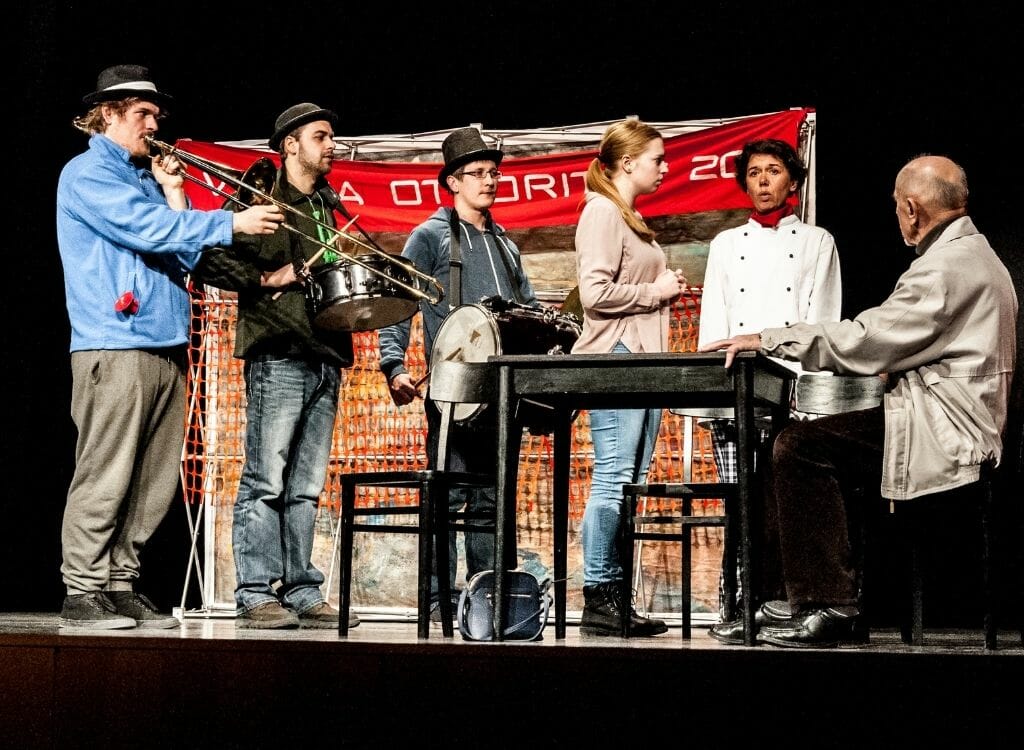 6 young people with instruments on a theatre stage