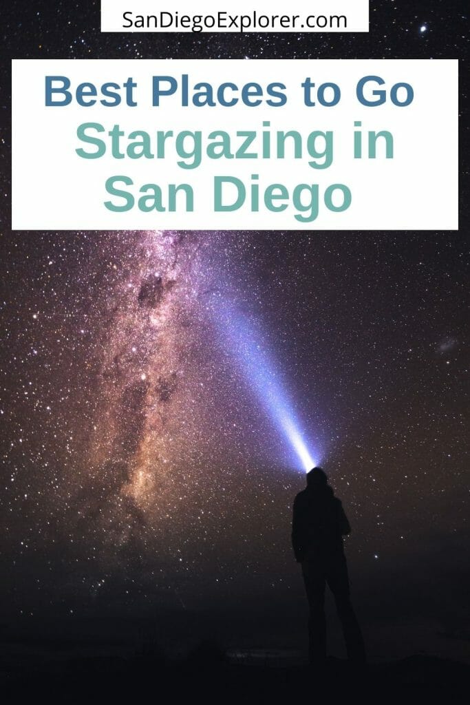 Milky way and starry sky, black silhouette of a person standing on a boulder flashing a beam of light into the dark night sky - Stargazing in San Diego is quite spectacular. Here are our favorite places and best tips to see the stars in and around San Diego, California.