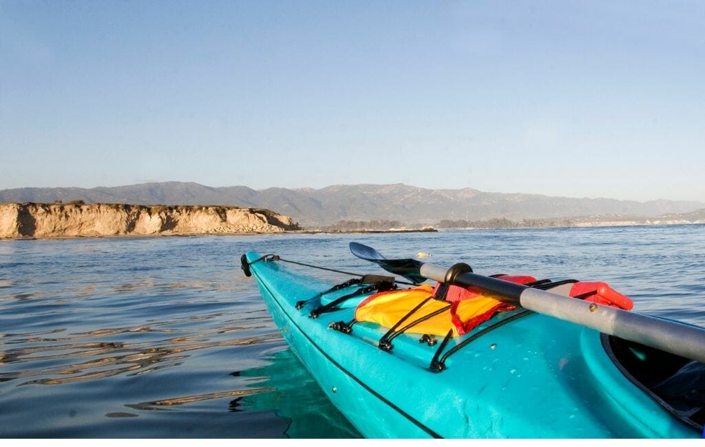 Turquoise Kayak on the right bottom of photo pointing towards Southern California Coast line