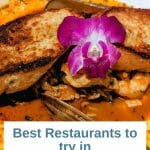 Chioppino seafood stew with garlic plate and decorated with a purple orchid - white box with text overlay: Best Restaurants to try in Dana Point, CA - If you’re into great seafood and dining with a view, Dana Point Harbor restaurants have you covered. Here are our favorite ones: