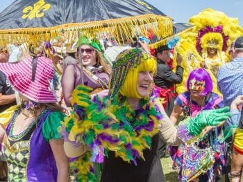 people dressed up in Mardi Gras Colors at the Gators by the Bay Festival in San Diego
