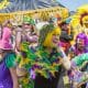 people dressed up in Mardi Gras Colors at the Gators by the Bay Festival in San Diego