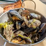steamed mussels in a metal bowl