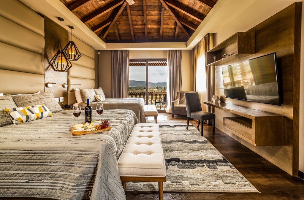 Luxurious hotel room with natual color scheme, wood and light grey/beige fabrics at El Cielo resort - best Valle de Guadalupe Hotels