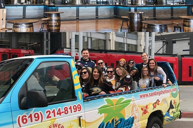 Open air convertable van with seats in the back, no roof full of people who take part in a San diego Brewery tour