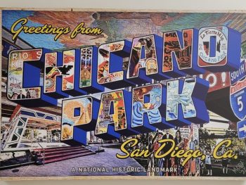 Wall mural painted like a postcard reading "Greetings from Chicano Park San Diego, Co. A National Historic Landmark". Chicano Park murals, Barrio Logan.