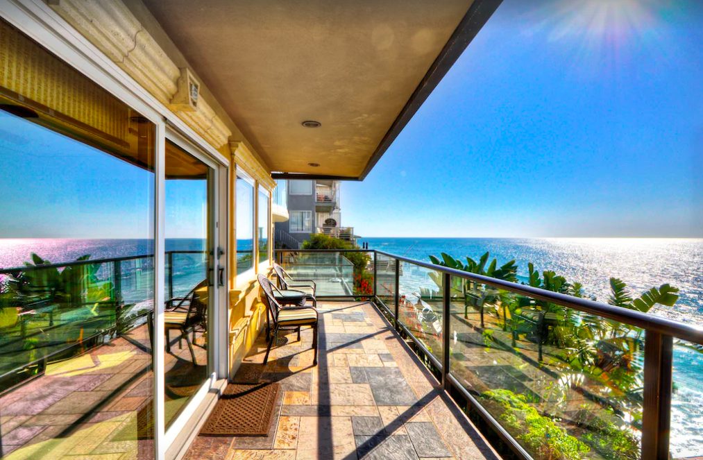 Small condo balcony overlooking Pacific Ocean on sunny day. Laguna Beach vacation rentals.