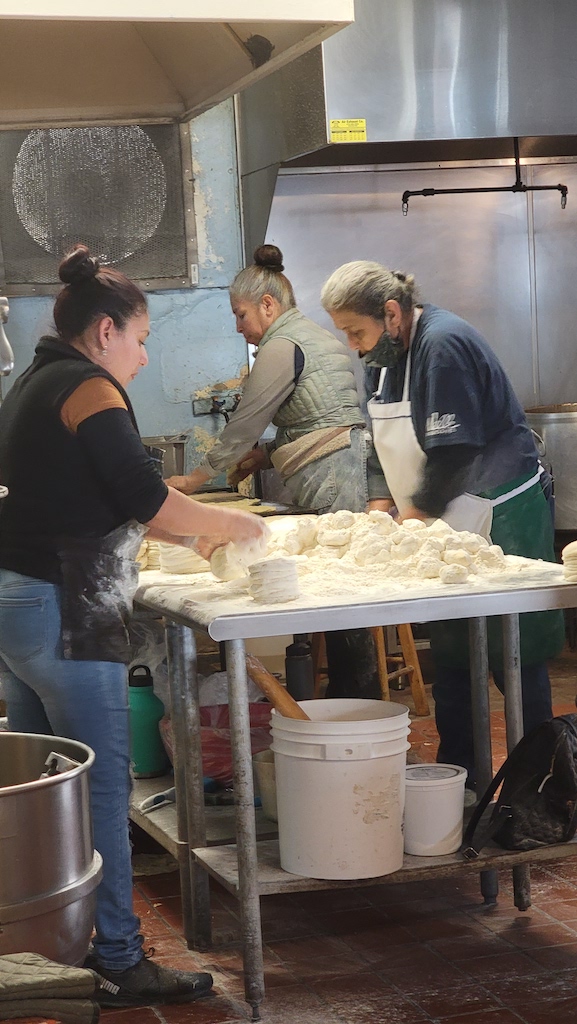Women making homemade tortillas in restaurant kitchen. Las Cuatro Milpas Tortilla Makers. Barrio Logan Tacos.