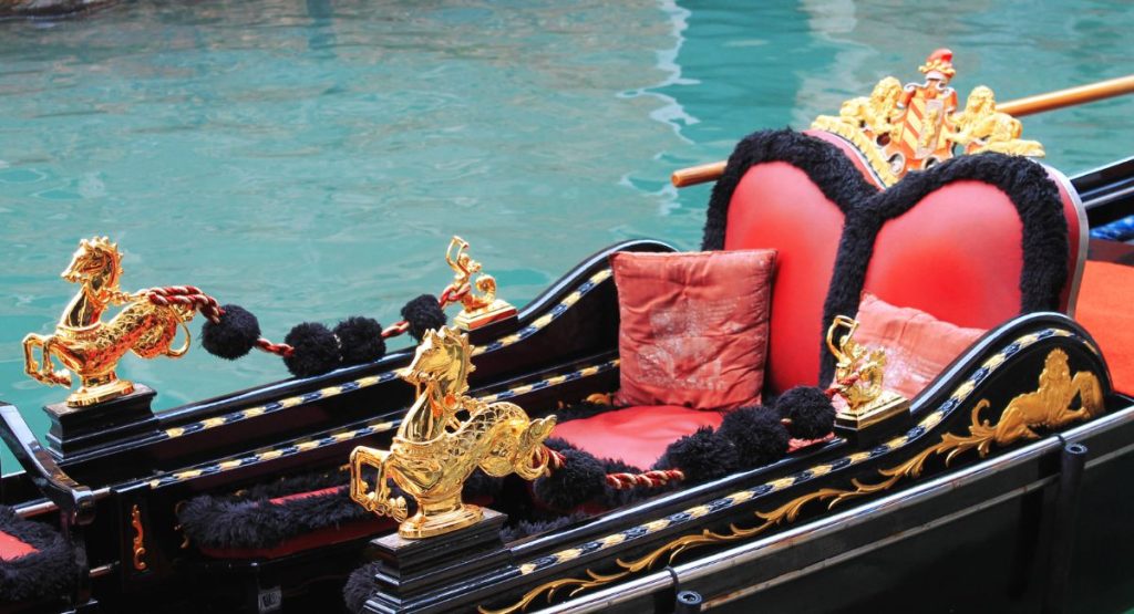 Close up of a Venetian Style Gondola with red leather seats and black wood - Things To Do in Coronado Island