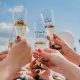 Close up of champagne toast, champagne glasses read "team bride" on sunny day. San Diego bachelorette party.