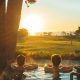 Couple in outdoor jacuzzi watching sunset over golf course and ocean in the distance. The Lodge at Torrey Pines Best hotels in San Diego for Couples