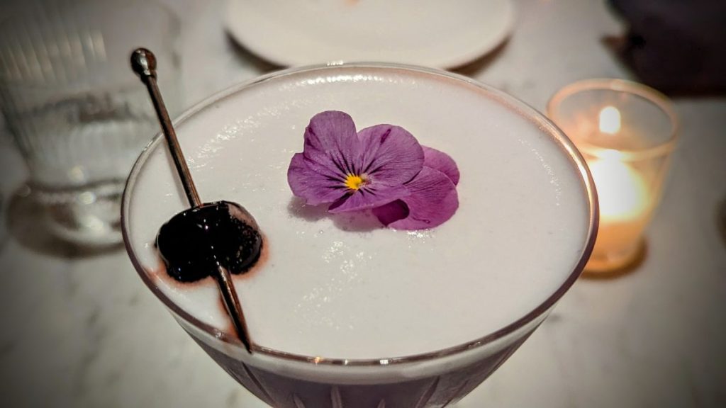 Lilac Gin Cocktail with egg foam and cherry