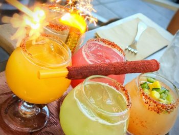 4 flavors of mimosas with tamarind straw and firey sparkler at King and Queen cantina