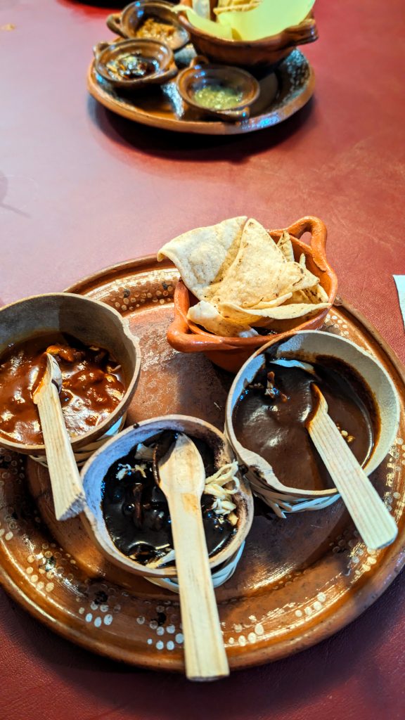 Appetizer with three small pots of different Mole sauces