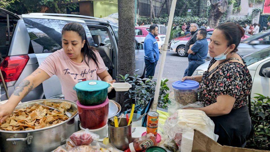 Ladies selling Chilaquiles in a street food stall in Mexico City